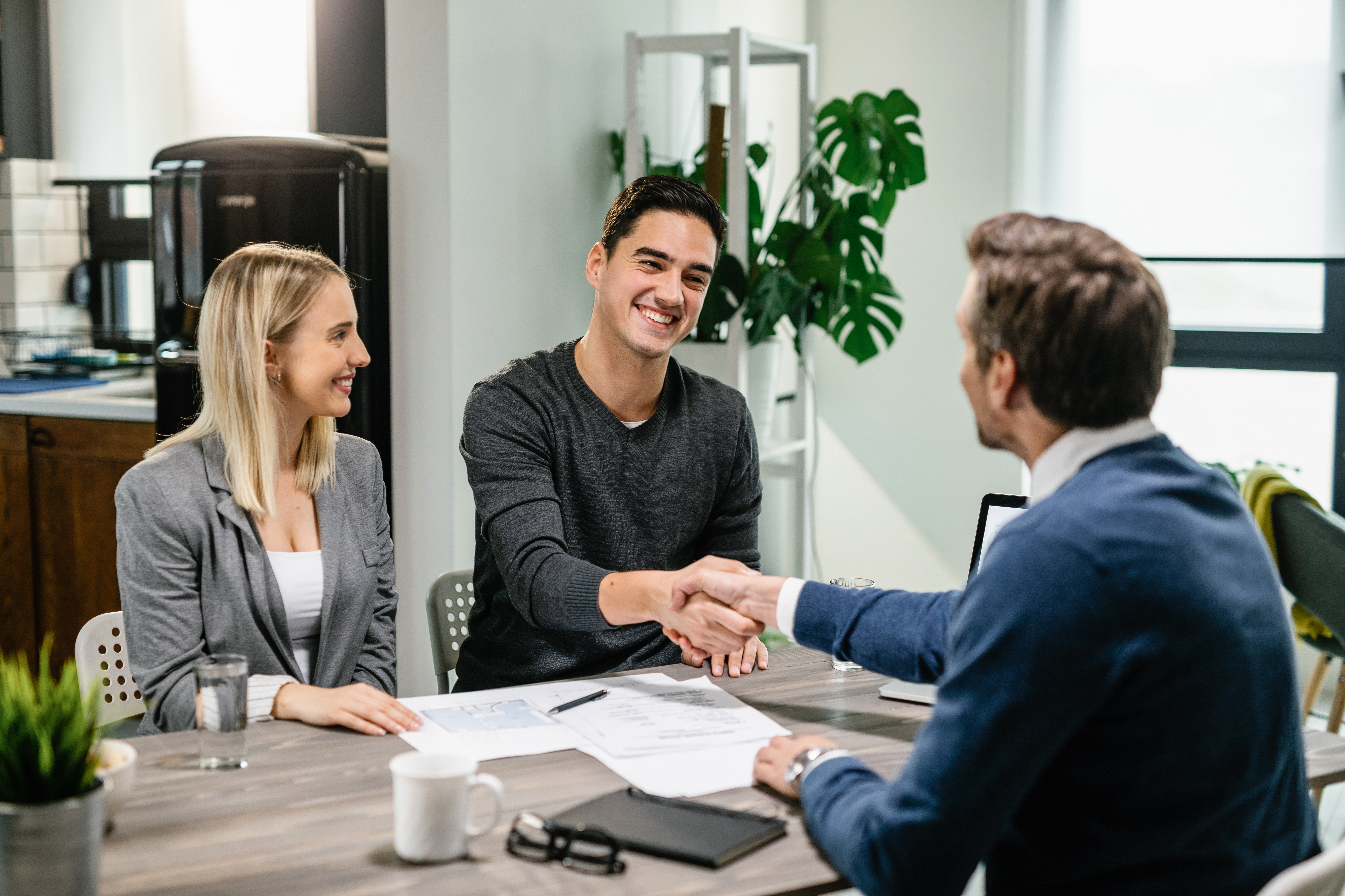 Small business owners meeting with an insurance advisor to discuss business insurance coverage.