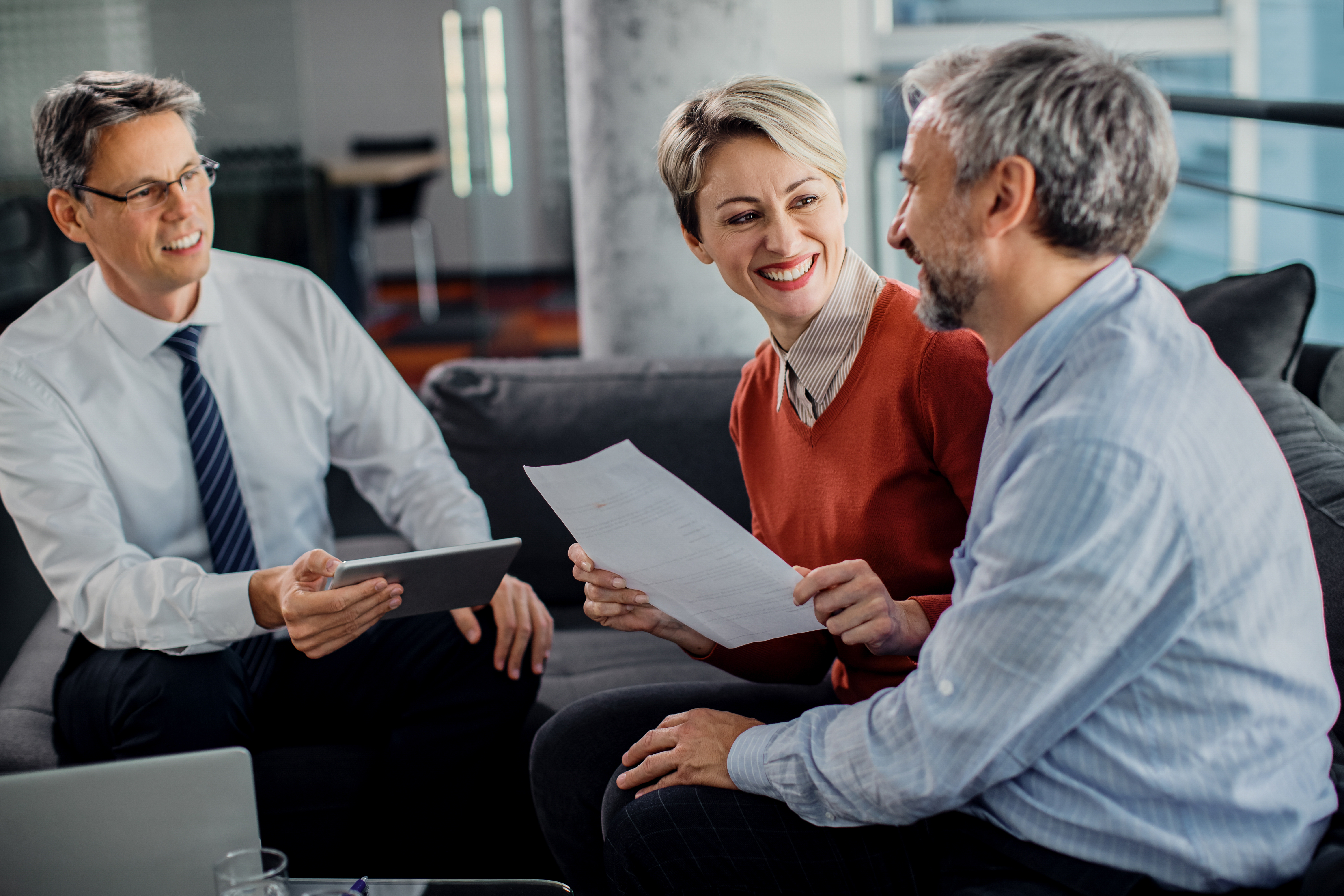 Independent insurance agent helping clients compare multiple insurance coverage options