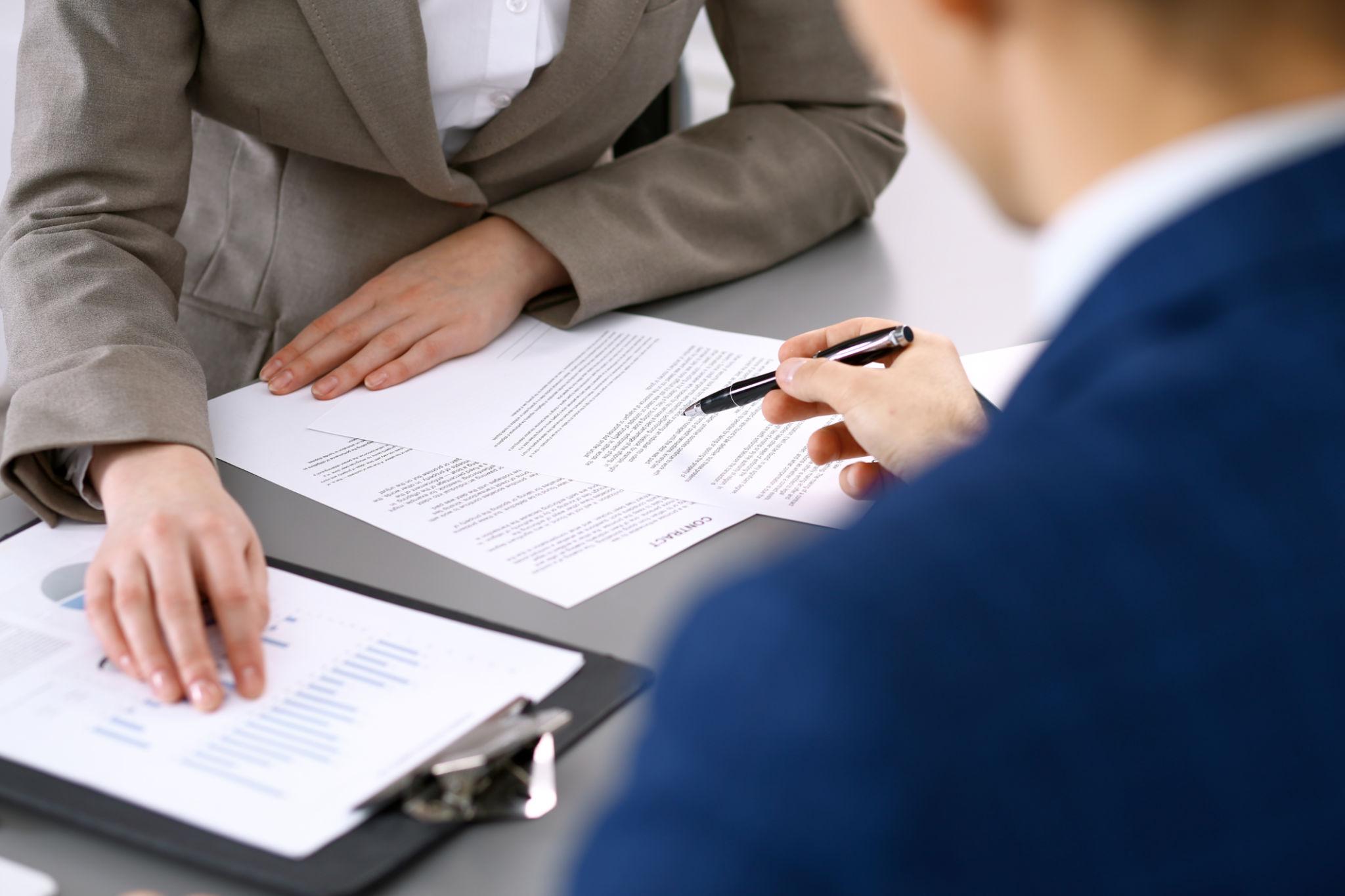 Professional reviewing documents related to general and professional liability insurance coverage.